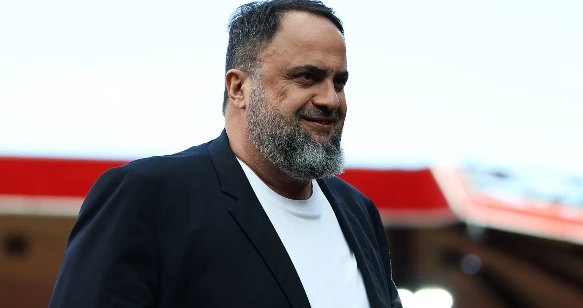 A man walking in a black suit and white shirt A man walking in a black suit and white shirt