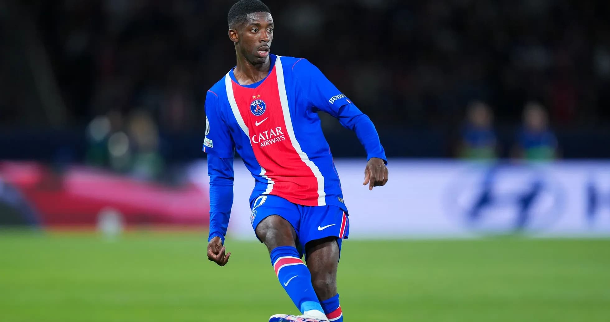 PSG player dribbling the ball on the field PSG player dribbling the ball on the field