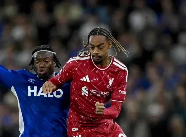 Liverpool player evading defender during match Liverpool player evading defender during match
