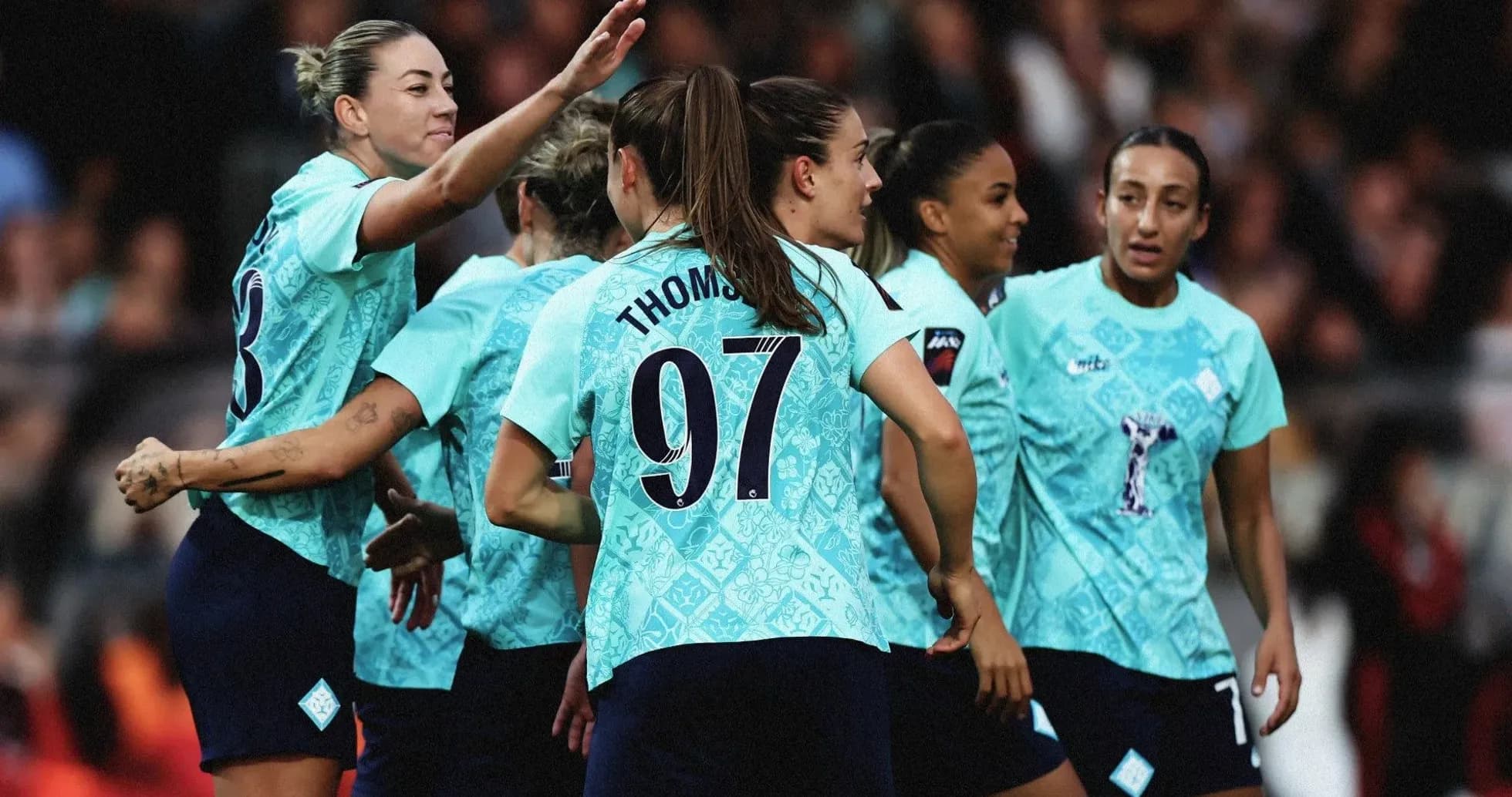 Women's football team celebrating a goal together Women's football team celebrating a goal together