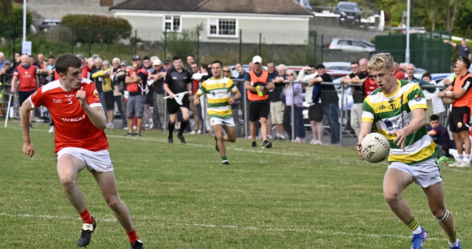 Player passing the ball during a Gaelic football match Player passing the ball during a Gaelic football match