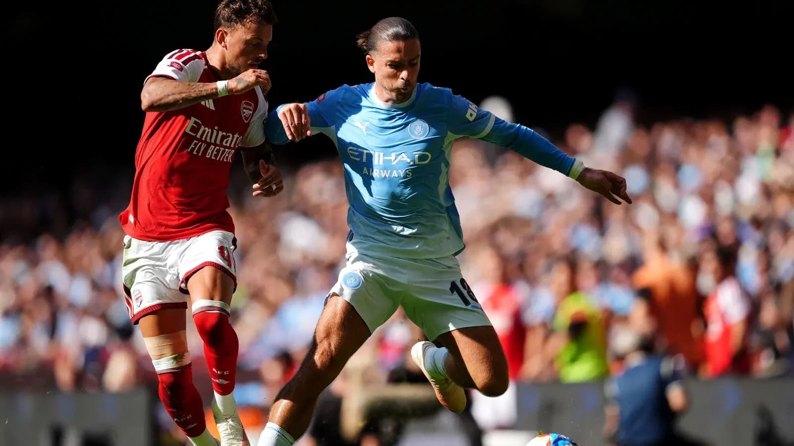 Arsenal and Manchester City players contesting the ball Arsenal and Manchester City players contesting the ball