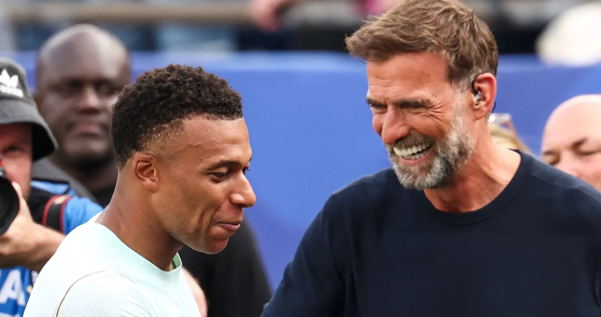 Two men smiling and interacting at event Two men smiling and interacting at event