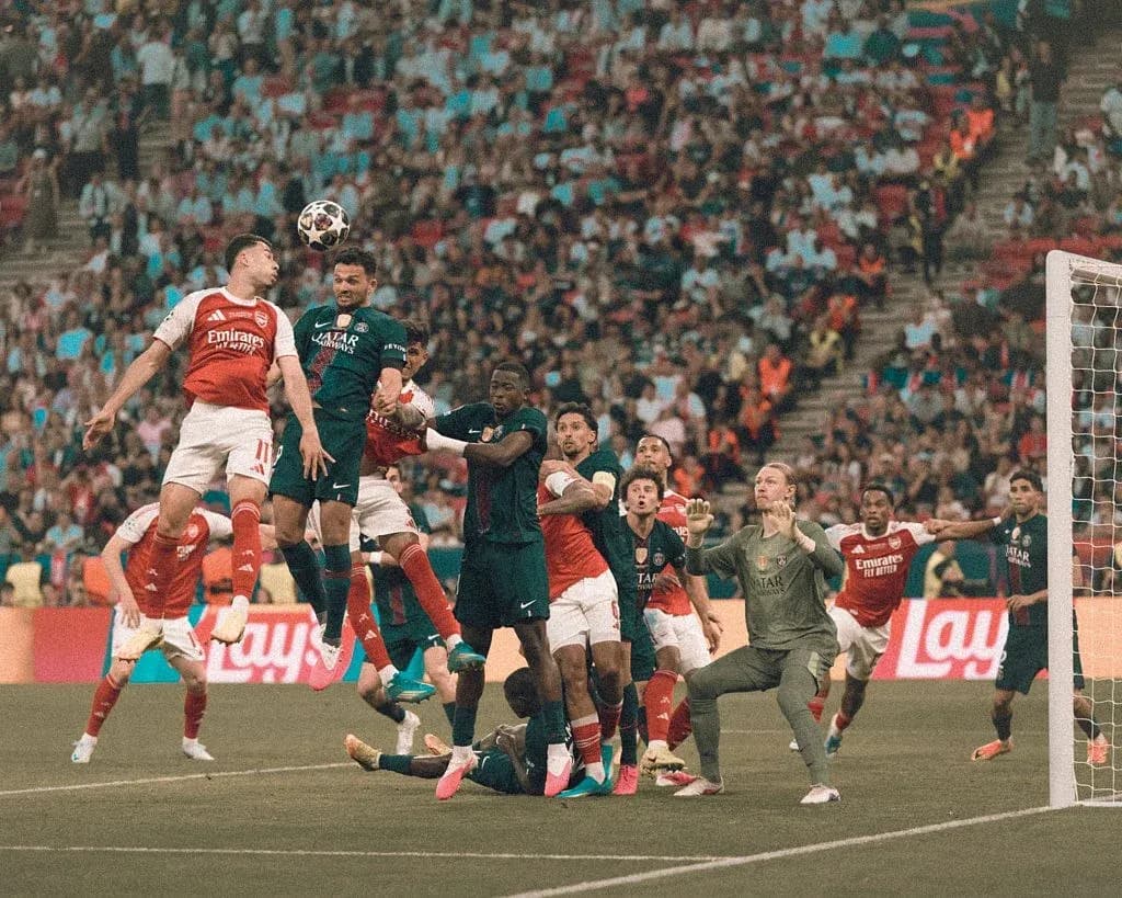 Players competing for the ball during corner kick Players competing for the ball during corner kick