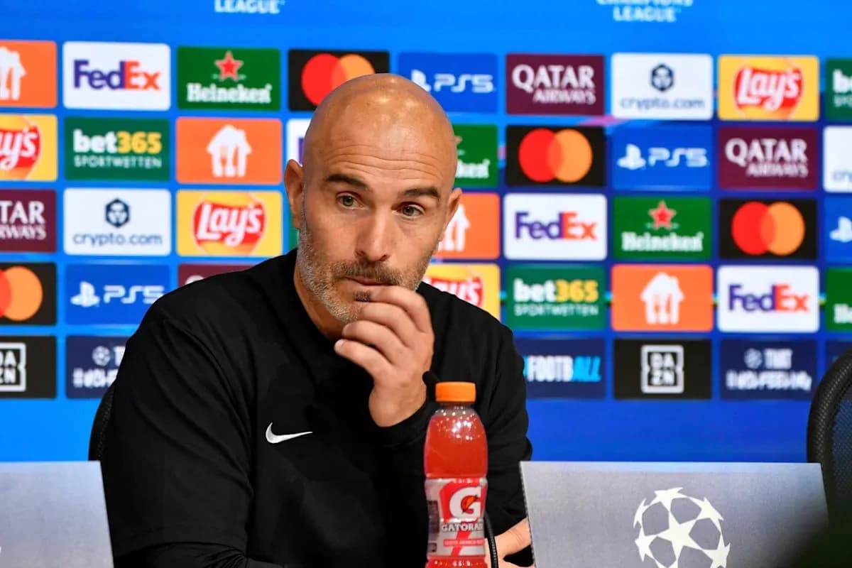 Men's football manager at press conference podium Men's football manager at press conference podium