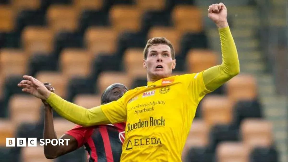 Player in yellow shirt competing for the ball Player in yellow shirt competing for the ball