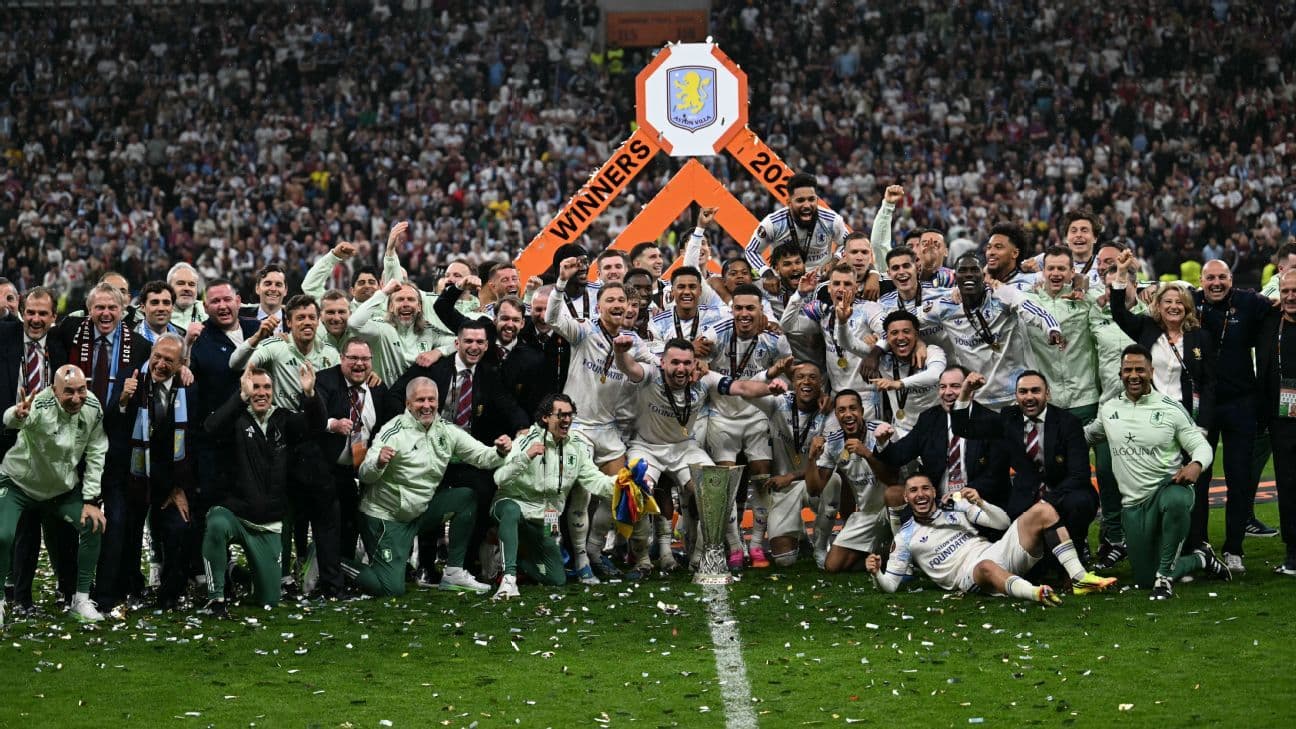 Aston Villa players celebrating trophy win on field Aston Villa players celebrating trophy win on field