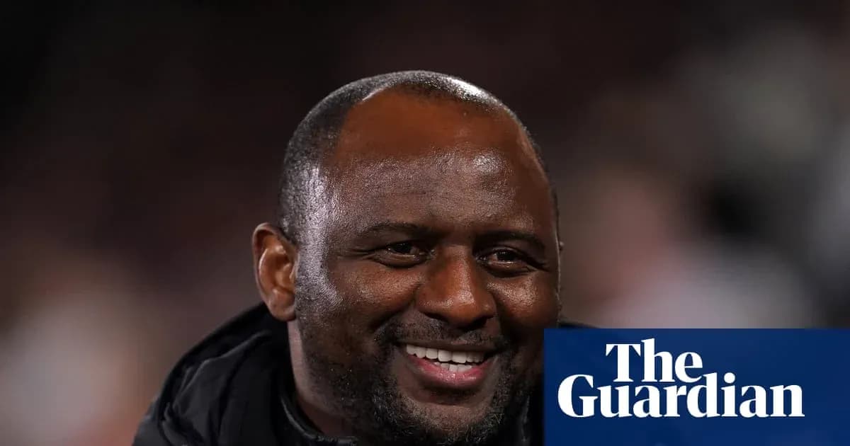 Football manager smiling during a match Football manager smiling during a match