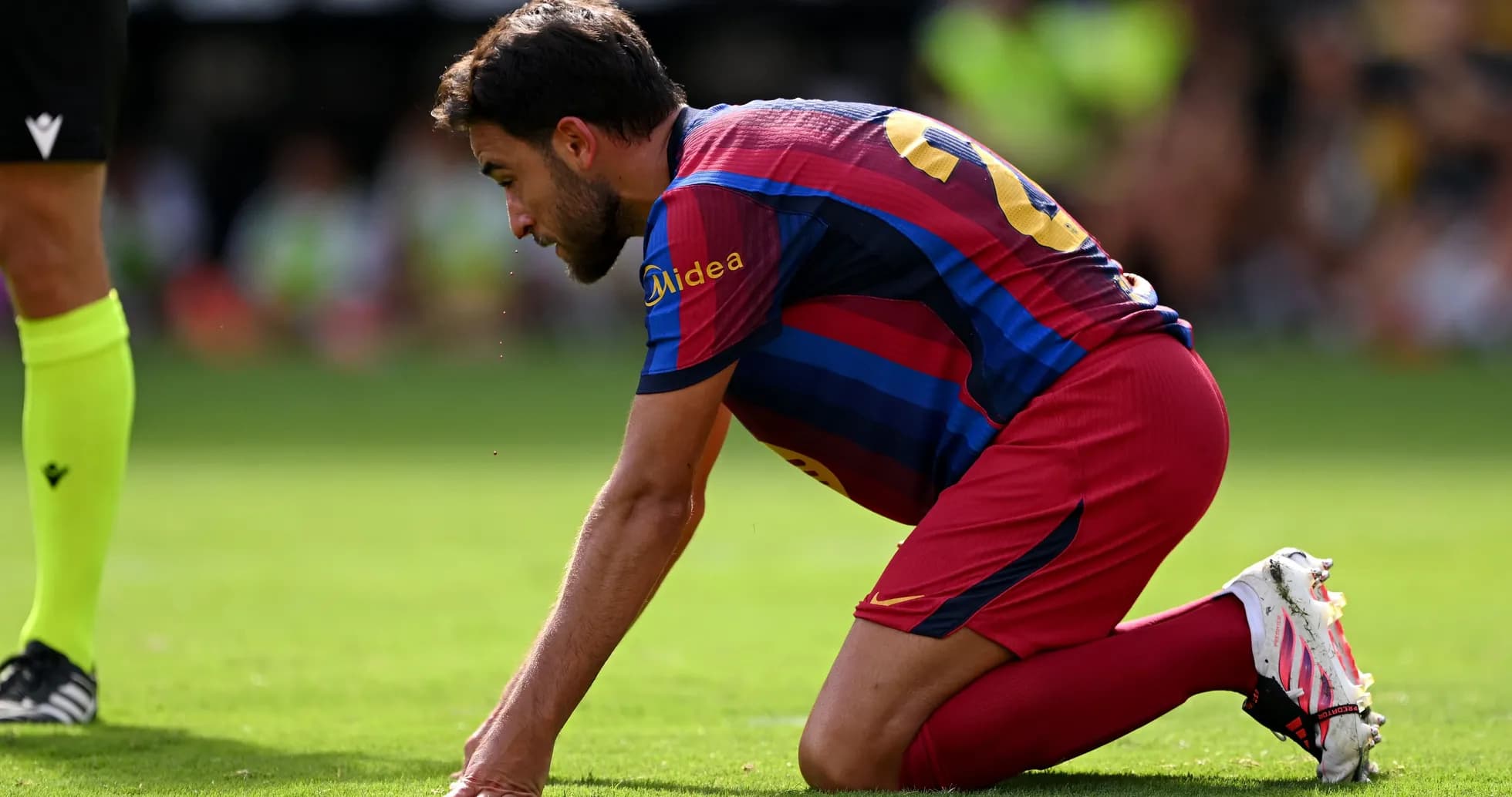 Player on knees during match on the field Player on knees during match on the field