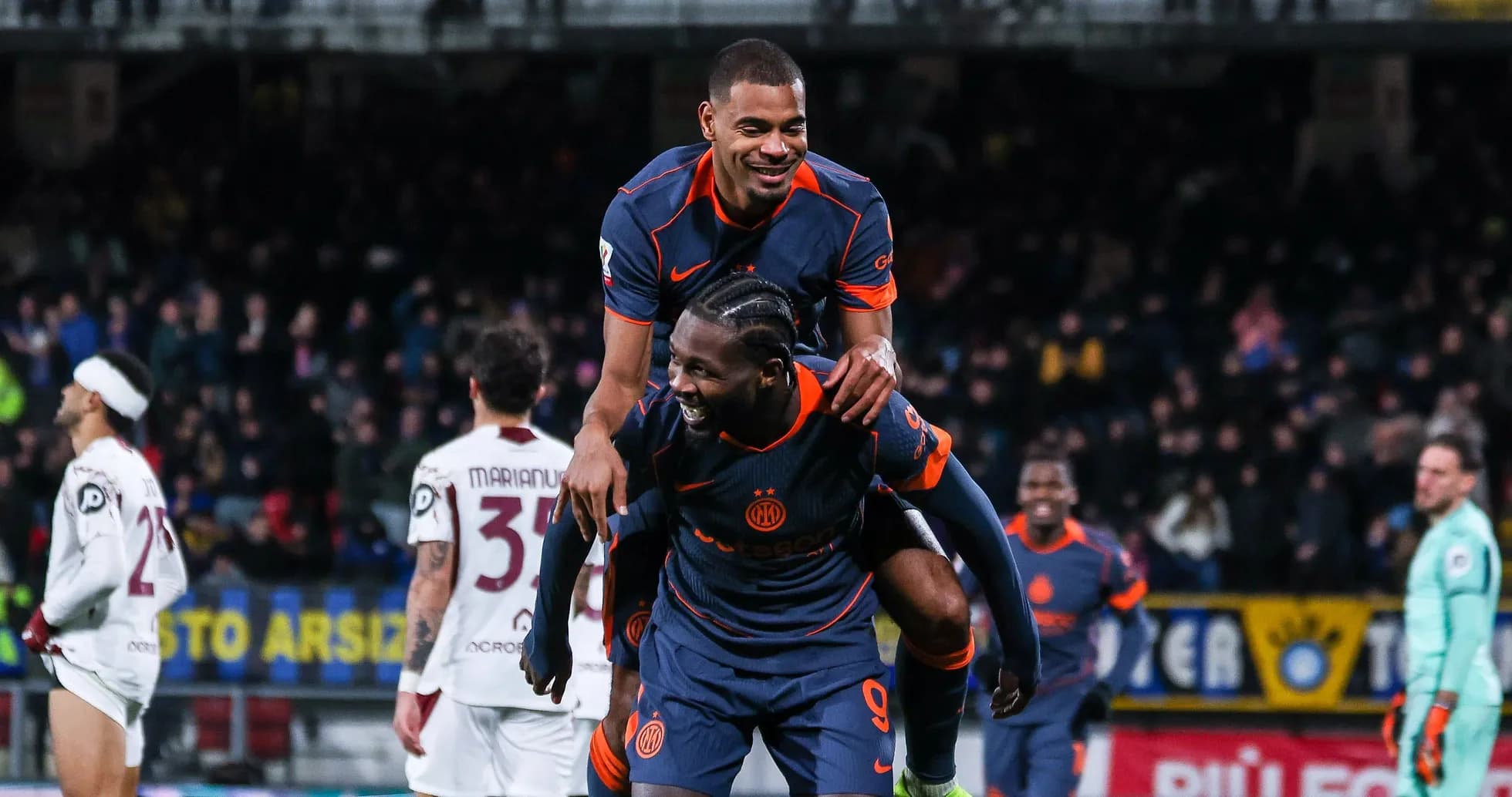 Players celebrating on the field after a goal Players celebrating on the field after a goal