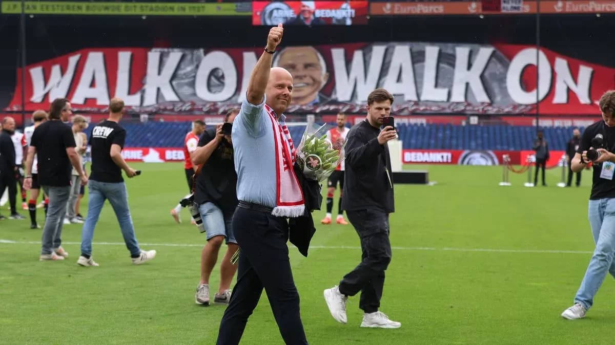 Person waving with flowers on football pitch Person waving with flowers on football pitch