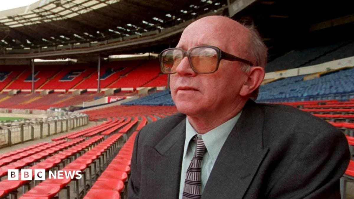 Man wearing glasses seated in empty stadium Man wearing glasses seated in empty stadium