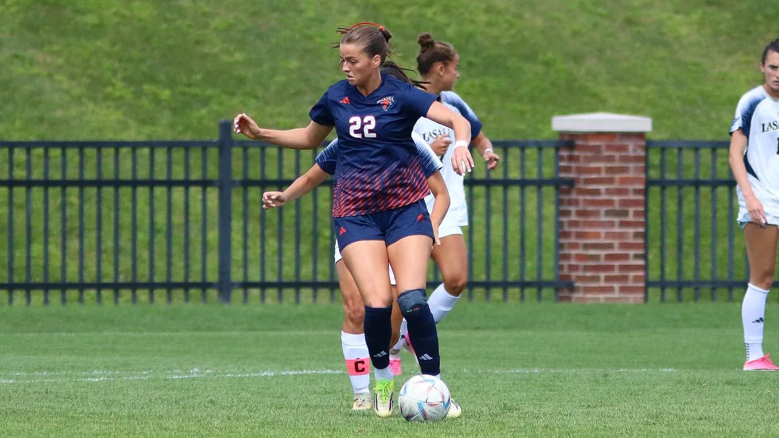 Player dribbling the ball during a soccer match Player dribbling the ball during a soccer match