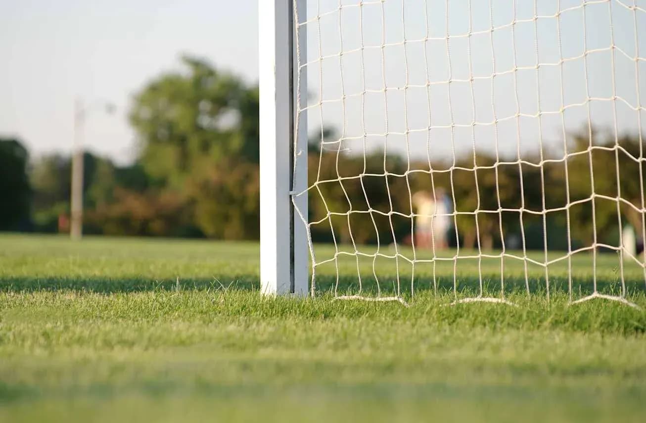 Close-up of soccer goalpost and net on field Close-up of soccer goalpost and net on field