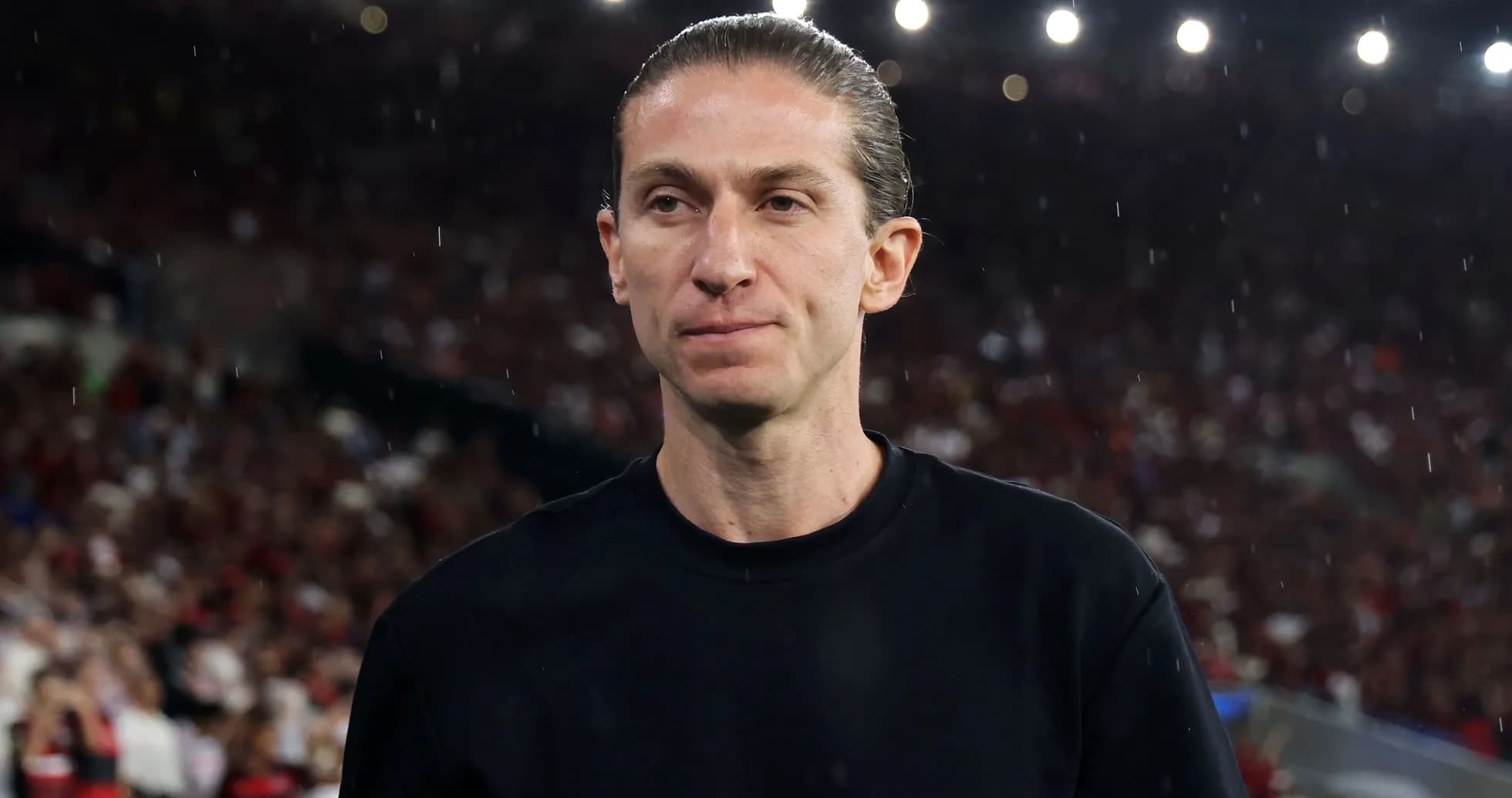 Individual in black shirt at crowded stadium Individual in black shirt at crowded stadium