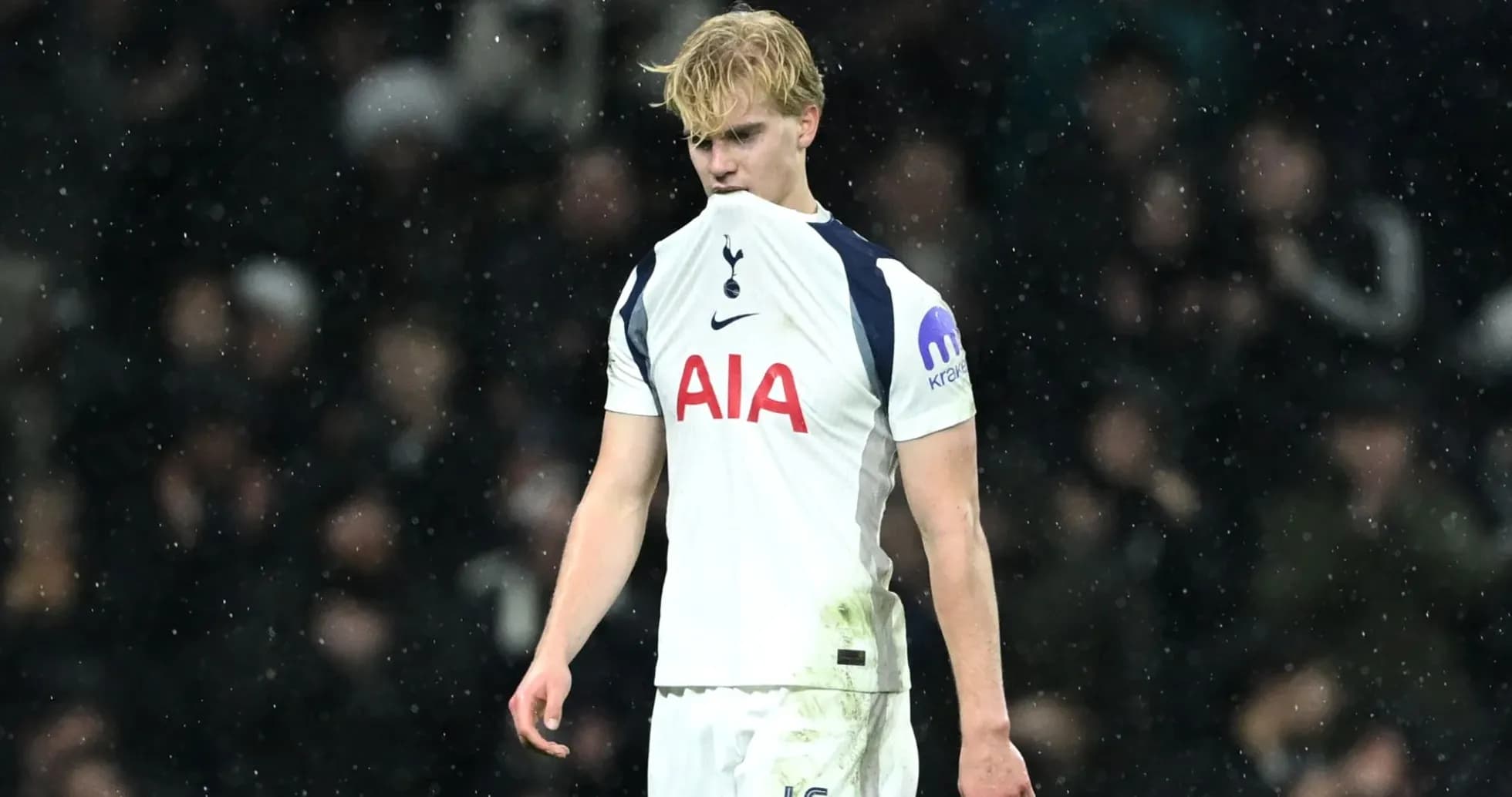 Tottenham player looking down during rainy match Tottenham player looking down during rainy match