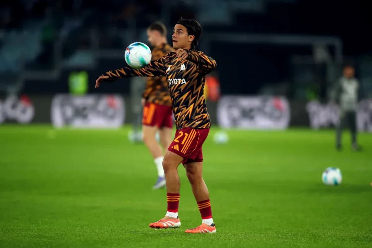 Player warming up and juggling ball on pitch Player warming up and juggling ball on pitch