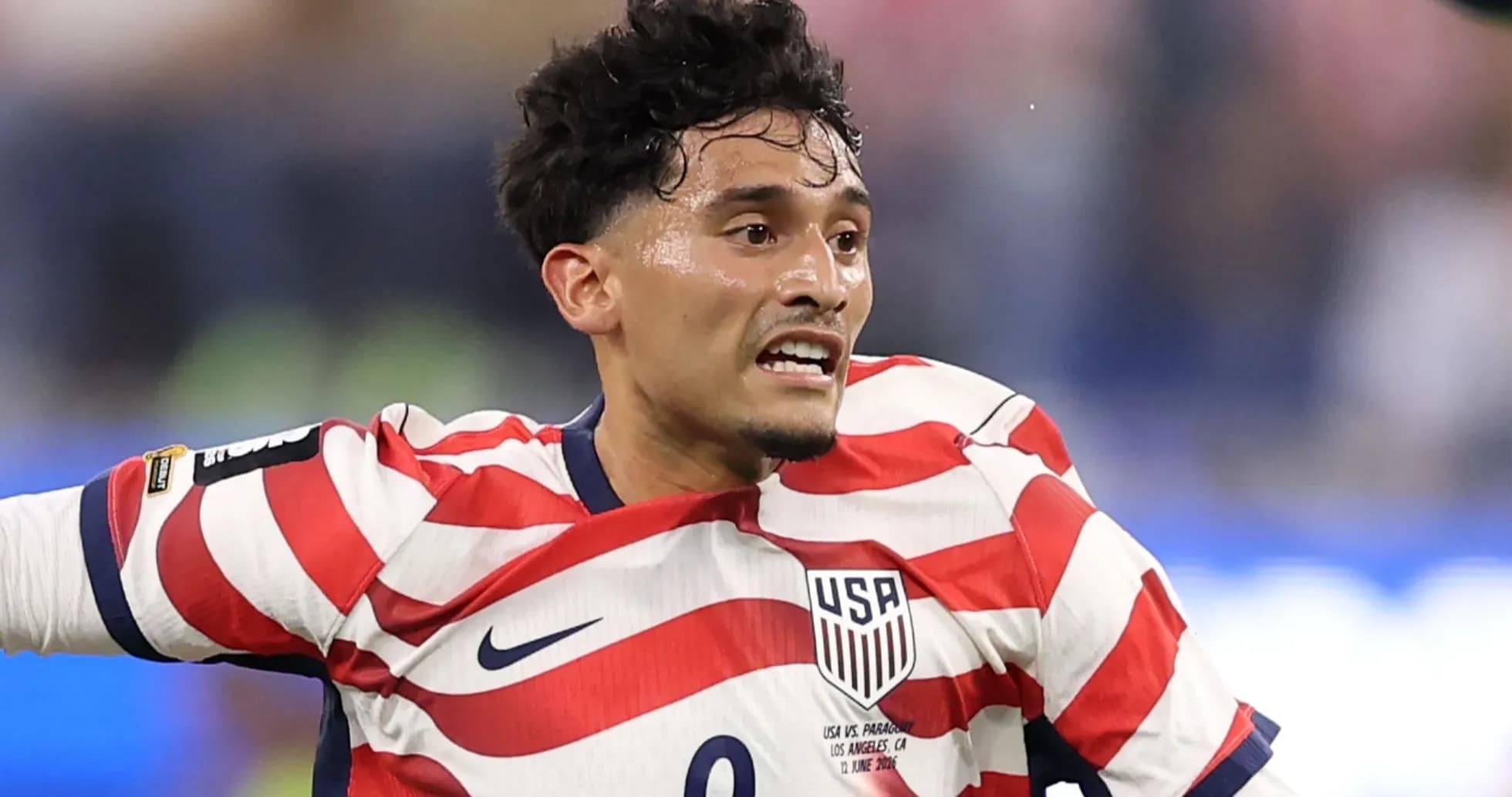 USA player in striped jersey during match action USA player in striped jersey during match action